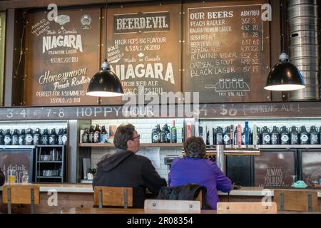 Clients regardant le menu Board à l'intérieur de Niagara Brewing Company Pub Niagara Falls, Ontario, Canada. Pub. De la microbrasserie canadienne Brew Banque D'Images