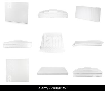 Set avec de nouveaux matelas confortables sur fond blanc Banque D'Images