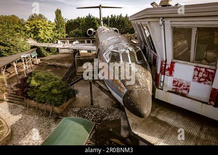 Une image hantante d'un avion abandonné reposant près d'une tour de contrôle désaffectée, capturant l'atmosphère étrange. Banque D'Images