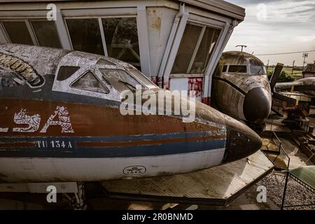 Une image hantante d'un avion abandonné reposant près d'une tour de contrôle désaffectée, capturant l'atmosphère étrange. Banque D'Images