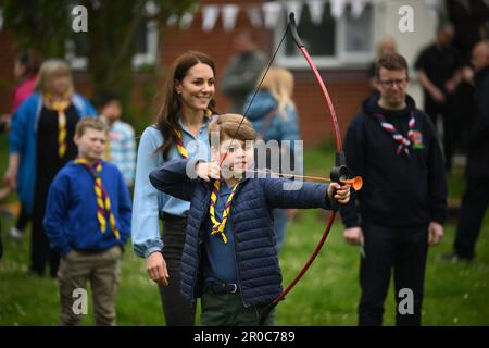 Le Prince George, observé par la princesse de Galles, tente de tir à l'arc tout en se joignant à des volontaires pour aider à rénover et améliorer la cabane des Scouts Upton 3rd à Slough, dans le cadre de l'aide à la grande sortie, pour marquer le couronnement du roi Charles III et de la reine Camilla. Date de la photo: Lundi 8 mai 2023. Banque D'Images