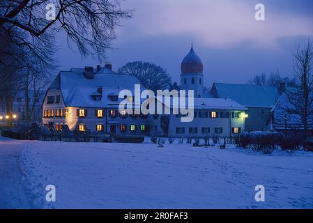 Maisons enneigées sur l'île Fraueninsel dans la soirée, lac Chiemsee, Bavière, Allemagne Banque D'Images