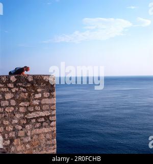 Touristes regardant sur le mur de la ville à la mer Adriatique, Dubrovnik, Dalmatie, Croatie Banque D'Images