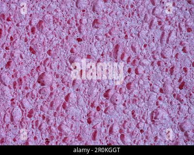 Texture détaillée de l'éponge à vaisselle, fond rose abstrait Banque D'Images