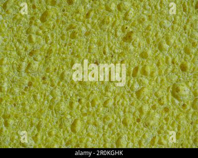 Texture éponge pour laver la vaisselle, fond jaune abstrait Banque D'Images