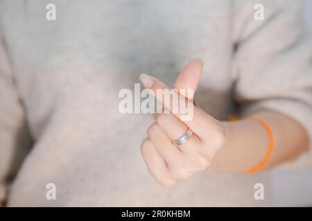 gros plan main femelle montrant le petit coeur sur un fond blanc isolé, gros plan mini coeur signe par les femmes main saint valentin concept d'amour Banque D'Images