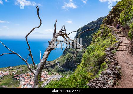 Une femme sur une pente raide au-dessus du village d'Agulo avec une vue sur l'île de Ténérife et le Mont Teide en arrière-plan, Agulo, la Gomera, Canary Banque D'Images