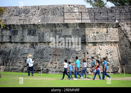 Touristes devant un temple à gradins avec des sculptures en pierre sur le site archéologique pré-colombien de Xochicalco à Cuernavaca, Mexique Banque D'Images