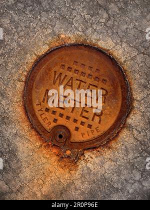 Détail de la texture du couvercle du compteur d'eau rouillée Banque D'Images