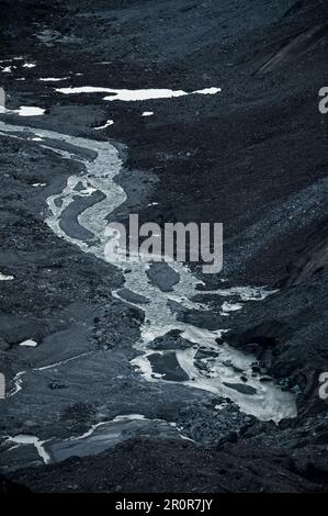 Ruisseau de meandering après Unteraargletscher avec Grimselsee lors d'une journée ensoleillée d'été Banque D'Images