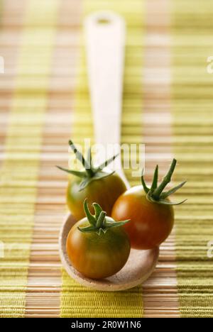 Tomates cerises sur une cuillère en bois Banque D'Images