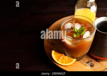 Savoureuse boisson rafraîchissante avec café et jus d'orange sur table en bois, en gros plan. Espace pour le texte Banque D'Images