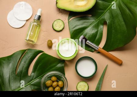 Composition avec des cosmétiques naturels, des ingrédients et des feuilles de palmier sur fond de couleur Banque D'Images