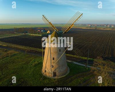 Le moulin à vent de Kunhegyes, situé en Hongrie, ce moulin à vent traditionnel en bois est haut dans la campagne, symbolisant l'héritag agricole de la région Banque D'Images