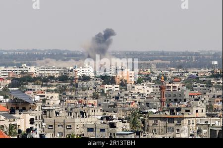 Rafah, Gaza. 11th mai 2023. Les Palistins se promènaient au milieu de débris devant le bâtiment abritant le plat (dernier étage) d'un chef militaire du Jihad islamique, détruit par une attaque aérienne israélienne à Khan Yunis dans la bande de Gaza, à Thunsday 11 mai 2023. L'armée israélienne et les militants de Gaza ont échangé de lourds tirs transfrontaliers du jour au lendemain, avec au moins 25 Palestiniens tués sur deux jours. Photo par Ismael Mohamad/UPI crédit: UPI/Alay Live News Banque D'Images