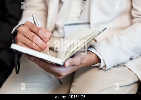 Des leçons de changement de vie dans les affaires. homme d'affaires méconnu prenant des notes pendant une conférence. Banque D'Images