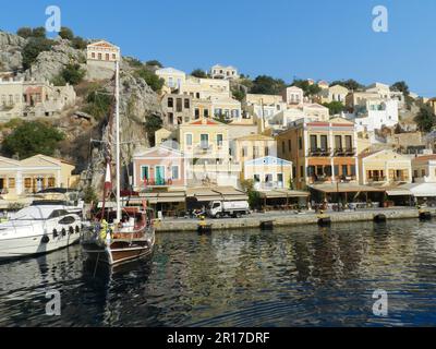 Grèce, île de Symi: S'éloigner de la jetée - réflexions de beaux bâtiments dans l'eau Banque D'Images