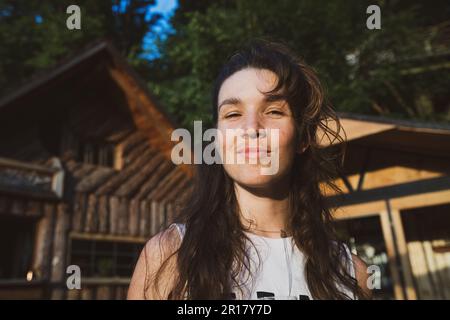 portrait naturel souriant d'une femme à l'extérieur avec des cheveux bouclés Banque D'Images