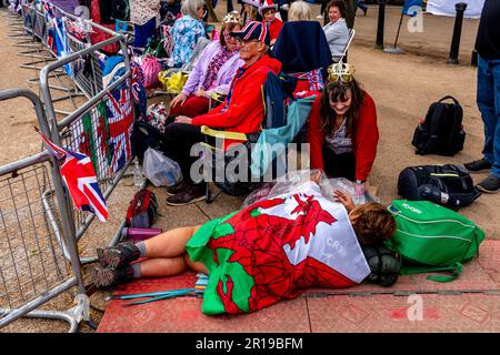 Les gens se rassemblent/campent dans le centre commercial pour regarder la procession du roi le jour avant le couronnement du roi Charles III, Londres, Royaume-Uni. Banque D'Images