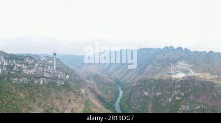 Qianxinan, Chine. 12th mai 2023. QIANXINAN, CHINE - 12 MAI 2023 - photo aérienne prise sur 12 mai 2023 montre le pont de la gorge de Huajiang en construction sur l'autoroute Liuzhi-Anlong à Qianxinan, province de Guizhou, Chine. Le pont Huajiang Canyon est un pont suspendu à poutres en acier d'une longueur totale de 2 890 mètres et d'une portée principale de 1 420 mètres. La différence de hauteur verticale entre le plancher du pont et la surface de l'eau est de 625 mètres. Le pont devrait être terminé en 2025. (Photo par Costfoto/NurPhoto) crédit: NurPhoto SRL/Alay Live News Banque D'Images