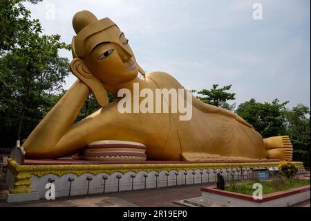 Statue couchée de 100 pieds de couleur dorée du Seigneur Bouddha, située au temple Vimukti Bibeshan Bhabna Kendra, Cox's Bazar, Bangladesh Banque D'Images