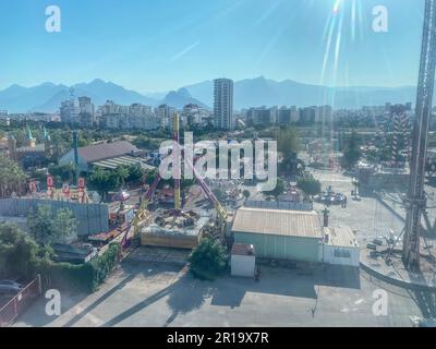 Vue panoramique de la ville à travers le verre depuis la cabine de la grande roue. les touristes à cheval dans un stand fermé, en métal, rond. tour du carrousel. Banque D'Images