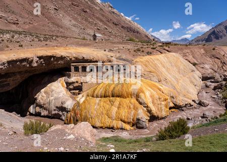 Dépôts de travertin colorés de la source minérale à Puente del Inca dans les Andes de l'Argentine, avec les ruines d'un ancien spa. Banque D'Images