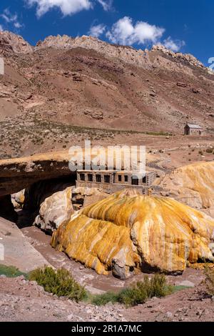 Dépôts de travertin colorés de la source minérale à Puente del Inca dans les Andes de l'Argentine, avec les ruines d'un ancien spa. Banque D'Images