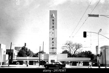 Photogrpah noir et blanc d'une voiture en voiture en passant par le panneau State Fair of Texas à Dallas Texas ca. 1963 Banque D'Images