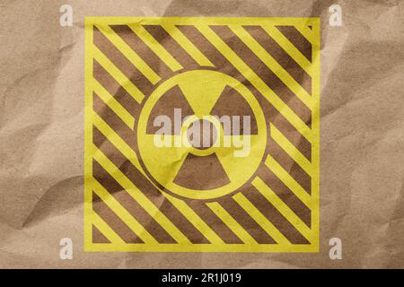 Signe radioactif sur papier kraft froissé. Symbole de danger Banque D'Images