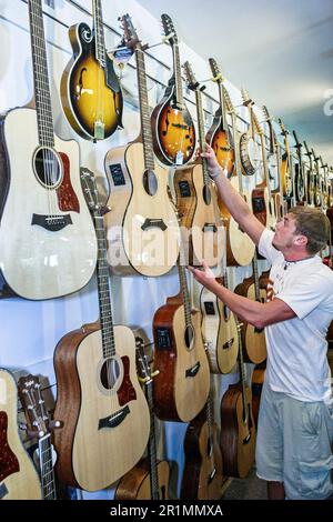 Sevierville Tennessee, magasin de magasins d'usine de musique affaires instruments de musique vente shopping, intérieur, guitares affichage homme client, Banque D'Images