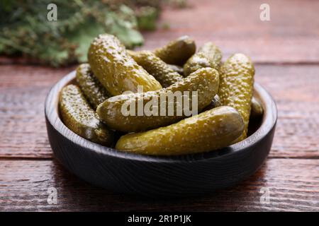 Assiette avec concombres marinés sur table en bois, gros plan Banque D'Images