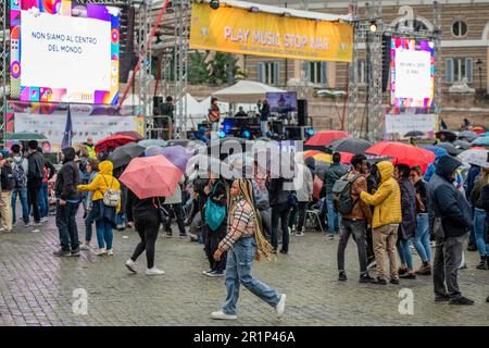 Des spectateurs tenant des parapluies assistent au concert pour la paix organisé par la Communauté de Sant'Egidio. "Play Music Stop War" sur la Piazza del Popolo, la deuxième édition du marathon de musique organisé par la Communauté de Sant'Egidio pour dire non à la guerre en Ukraine et à toutes les guerres. Les finalistes du concours de musique "Play Music Stop violence", promu par le mouvement Jeunesse pour la paix, étaient également sur scène: De jeunes artistes et groupes émergents ont proposé leurs chansons originales au nom de la paix, de la solidarité et de l'inclusion. La Communauté de Sant'Egidio est un mouvement laïc d'inspiration chrétienne catholique, dédié Banque D'Images