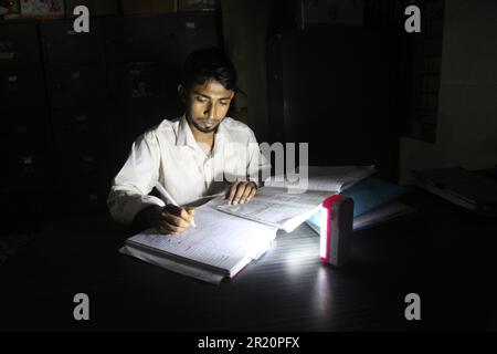 Délestage 16 may2023, paltan dhaka bangladeshA homme travaille avec le témoin du chargeur allumé en raison de l'délestage.photo a été prise paltan Dhaka Banclaies Banque D'Images