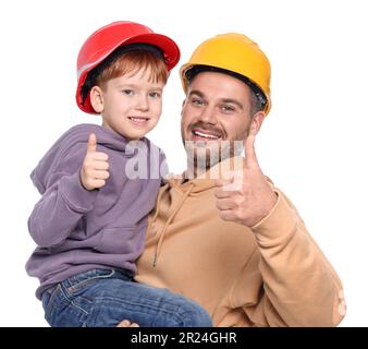 Père et fils en casques de sécurité montrant les pouces vers le haut sur fond blanc. Travaux de réparation Banque D'Images