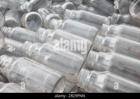 Bouteilles en verre vides utilisées stockées pour recyclage, mise au point sélective. Banque D'Images