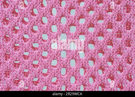 Texture macro de couleur rose sur la partie en maille de la chaise assise Banque D'Images