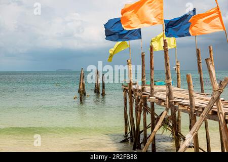 Jetée avec drapeaux colorés sur la plage d'Ao Wai, Koh Samet, Thaïlande Banque D'Images