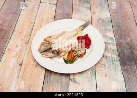 Salmoriglio est la sauce sicilienne traditionnelle la plus connue utilisée pour préparer de la viande grillée et du poisson, dans ce cas un bar de mer Banque D'Images