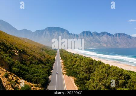 Kogelbay Beach Western Cape Afrique du Sud, Kogelbay Rugged Coast Line avec spectaculaire route de montagne. Garden route.couple homme et femmes marchant sur la route, vue de drone Banque D'Images