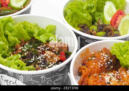 Poulet frit à la sauce épicée parsemé de sésame et de poulet katsu avec des légumes isolés sur fond blanc. concept de restauration rapide Banque D'Images