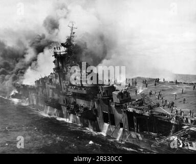 Le porte-avions américain USS Franklin s'arrête et est en feu le 19 mars 1945. Le Franklin a été frappé par deux bombes qui ont causé des dommages majeurs au transporteur. Le Franklin ne s'est pas fait couler et est retourné aux États-Unis pour réparation. Le navire a été mis hors service en 1947 et mis au rebut en 1966. Banque D'Images