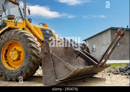 Détails du tracteur rouge moderne en gros plan. Grand tracteur de pelle hydraulique lourde industriel, puissant et jaune vif, bulldozer. Banque D'Images