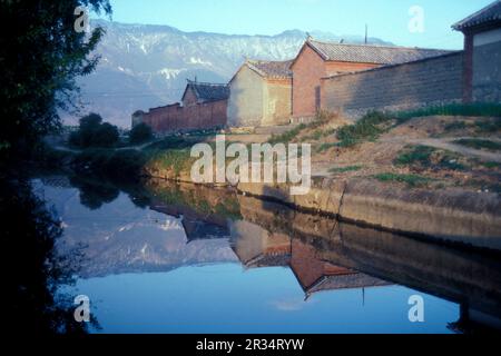 Une maison sur une rivière dans le paysage à la ville de Dali sur le lac ER Hai dans la province du Yunnan en Chine en Asie de l'est. Chine, Yunnan, avril 199 Banque D'Images