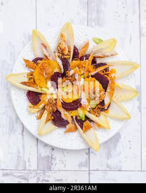 Salade avec chicorée, oranges, betteraves, maquereau fumé et noix Banque D'Images