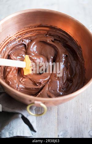 Crème au chocolat dans un bol à mélanger en cuivre Banque D'Images