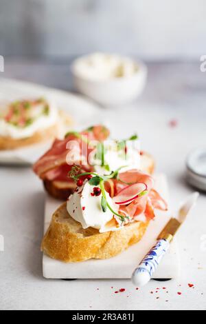 Bruschetta au prosciutto et fromage à la crème. Pain avec bacon fumé et fromage à la crème. Pain grillé Banque D'Images