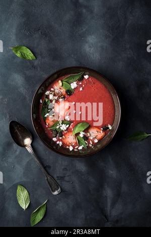 Soupe de crème à la fraise et au rhubarbe, épicée de gingembre et de cardamon, recouverte de feuilles de menthe frash, de fraises, de fromage feta, de graines de citrouille et de graines de chia Banque D'Images