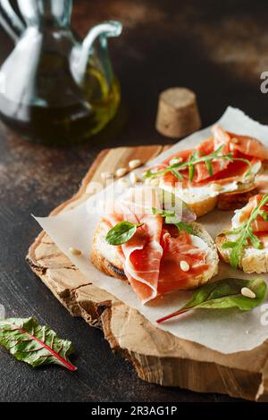 Antipasti traditionnels au jambon de parme. Ensemble de bruschetta avec jambon de Parme et parmesan. Petit sable Banque D'Images