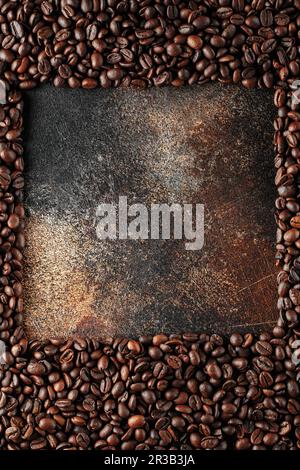 Grains de café noirs en studio. Grains de café fraîchement torréfiés comme fond de texture. Cadre de café Banque D'Images